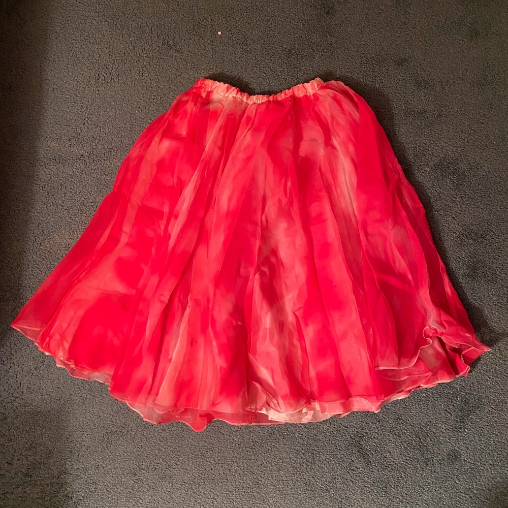 Red flowy skirt and red ornate jacket